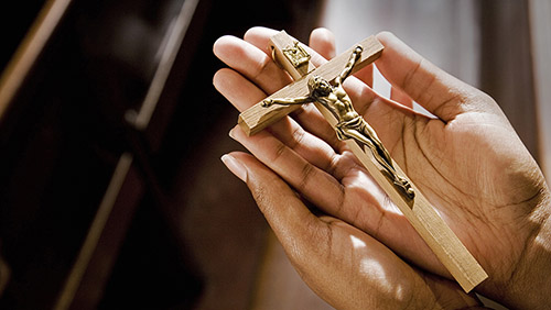 Image of hands holding a crucifix